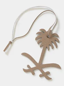Leather palm tree bag charm detail, luxury style car key pendant with fine hanging strap.
