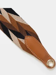 Wide woven replacement bag strap featuring geometric pattern and brown leather end.