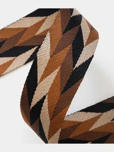 Detailed view of wide woven replacement bag strap in geometric black brown and beige pattern.