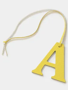 Yellow leather letter A bag charm keychain, stylish minimalist accessory for handbag.