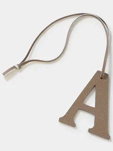 Leather letter A charm detail, stylish bag and key chain pendant accessory, premium look.
