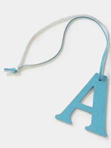 Blue leather letter A pendant charm, detailed close-up shot for bags and car keys.