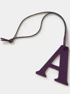 Purple leather letter A bag charm detail, premium textured cowhide keychain pendant.