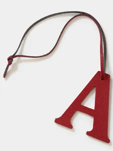 Leather letter A charm detail view, premium cowhide bag pendant and stylish keychain accessory.