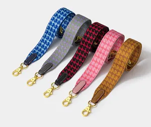 Colorful houndstooth woven replacement bag strap with gold metal swivel hooks and leather tabs.