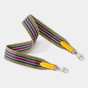 Colorful woven replacement bag strap with leather ends and metal hooks for crossbody bags.