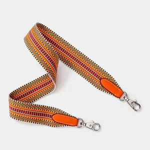 Woven replacement bag strap with vibrant colorful pattern and leather ends for luxury handbags.