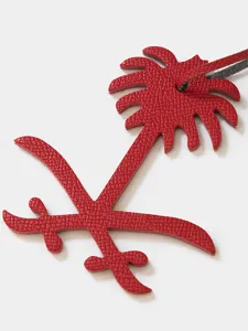 Red leather palm tree and sword bag charm stylish luxury keychain accessory for women.