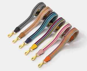 Colorful woven replacement bag strap with gold metal lobster clasps for luxury handbags.