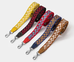 Replacement bag strap detail showcasing colorful chevron woven fabric and durable metal hardware.