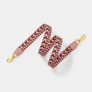 Stylish pink woven replacement bag strap with chic chevron pattern and gold-tone hardware.