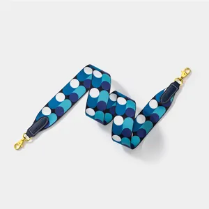Wide canvas bag strap replacement with blue geometric circle pattern and gold tone metal clips.