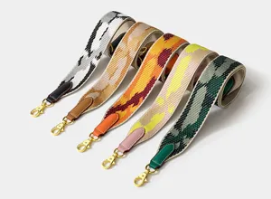 Wide woven replacement bag strap with leather ends and gold hardware for crossbody bags.