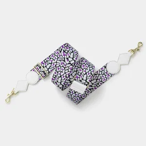 Adjustable wide bag strap replacement with purple leopard print and gold hardware details.