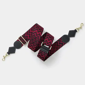 Adjustable wide replacement bag strap, red and black geometric woven pattern with gold hardware.