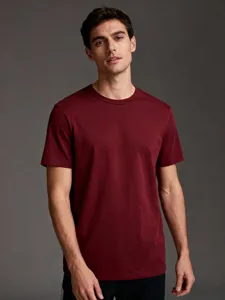 Detail view of men's burgundy short sleeve t-shirt, casual solid color crew neck top.