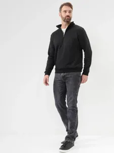 Detailed view of men's slim-fit straight jeans in dark grey, paired with a black sweater.