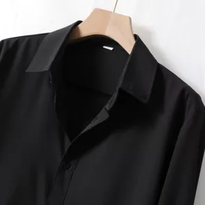Men's black long-sleeve business casual shirt detail view, professional wrinkle-free fabric.