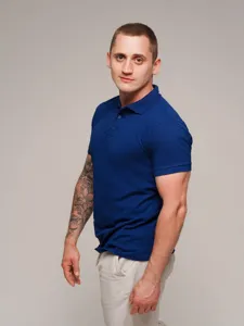 Detail view of the classic men's short sleeve polo shirt in royal blue, solid color style.