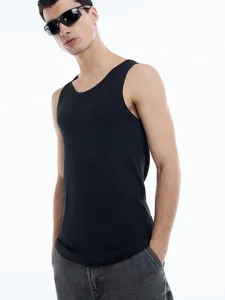 Detail view of men's 230gsm black cotton tank top, soft fabric and comfortable fit.