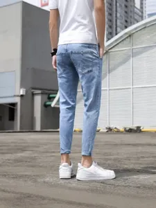 Men's light blue slim fit cropped jeans, stylish denim trousers for casual summer wear.