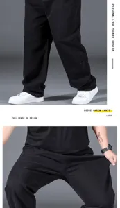 Detailed view of men loose black denim harem pants, showing comfortable elastic fabric fit.
