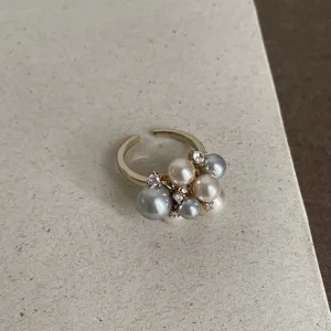Elegant open ring featuring mixed-size multi-color pearls and sparkling accent crystals.