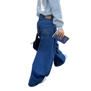 Detailed view of dark blue washed men's loose wide-leg non-stretch denim jeans with straight drape.