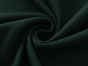 Close-up detail shot of dark green breathable cotton pique fabric texture with soft swirl.