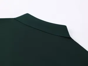 Dark green cotton men polo shirt collar detail, premium fabric texture, casual apparel.