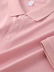 Detailed close-up view of the pink cotton polo shirt collar, placket and button texture.