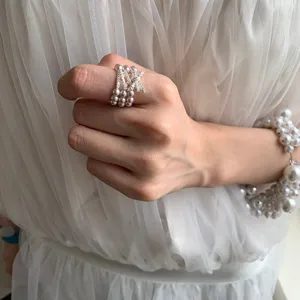 Three-layer pearl ring with sparkling rhinestone bow, elastic band chic fashion jewelry.