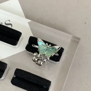 Y2K green butterfly open ring detail shot, trendy stackable metallic finger jewelry piece.