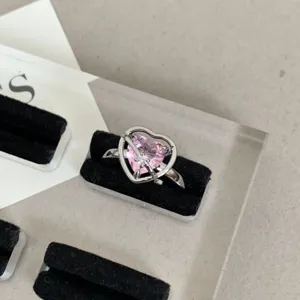 Y2K pink heart crystal ring detailed shot, trendy silver stacking finger jewelry piece.
