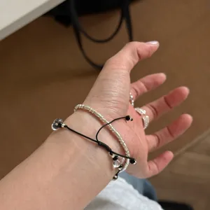 Dainty white crystal bracelet set with chic silver beads and black cord for daily wear.