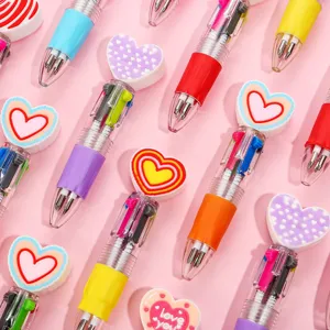 Detailed close-up view of cute multi-color ballpoint pens featuring adorable heart toppers.