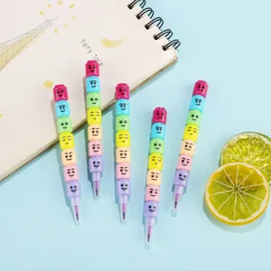 Detail shot of colorful stackable block crayons with cute expressions on a blue background.