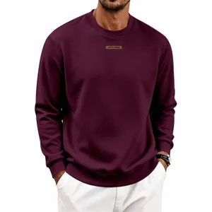 Men's burgundy crewneck sweatshirt featuring chest patch detail, comfortable casual pullover.