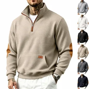 Men's quarter-zip waffle knit pullover sweater detail showing stand collar and elbow patch.
