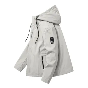 Grey hooded windbreaker jacket detail view, featuring functional zipper pockets and casual style.