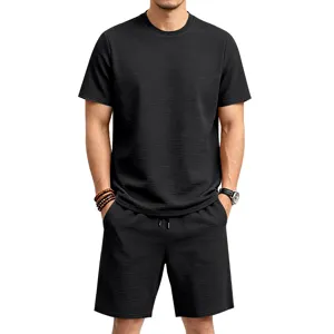 Detailed view of men's black textured short sleeve shirt and elastic shorts casual summer set.
