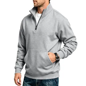 Detail view of men's grey half-zip fleece sweatshirt with kangaroo pocket and stand collar.