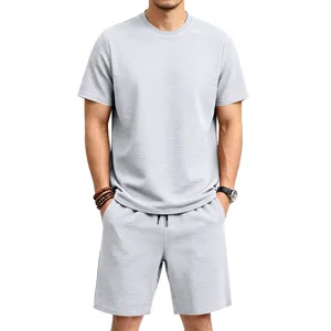 Detailed view of men textured short sleeve t shirt and shorts set in light grey casual summer wear.