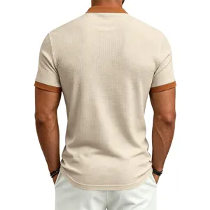 Back view detail of men's waffle knit short sleeve polo shirt in beige with brown contrast.