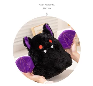 Close-up of cute black plush bat toy featuring purple wings, red eyes, and soft fabric.