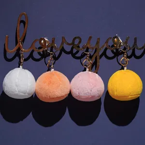Cute plush dumpling keychain set featuring four colorful soft bun pendants for bags and keys.