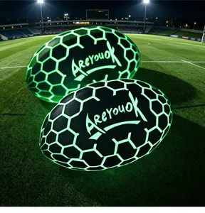 Detailed view of glowing rugby plush pillow with honeycomb pattern on night field background.