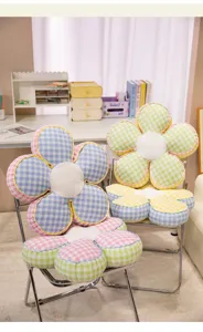 Cozy plaid flower cushion detail showing soft plush center and pastel checkered petals.