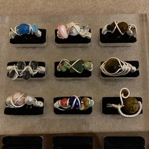Handmade wire wrapped rings detail featuring pearls, tiger eye stones and ceramic beads set.