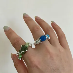 Handmade wire wrapped gemstone ring close-up showcasing unique natural stone bead detail.